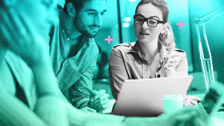 woman showing man something on computer screen