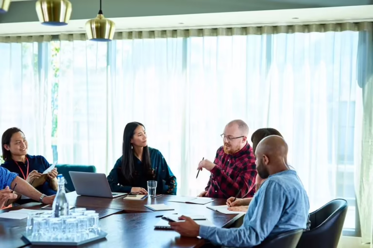 man talking to group in conference room