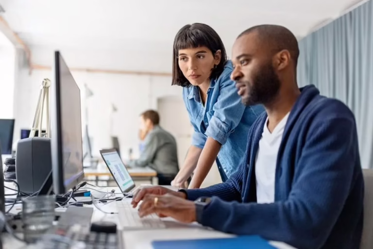 two people collaborating at a computer