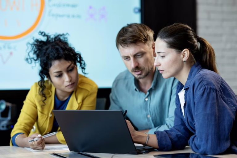 expert insights header image people sitting around laptop